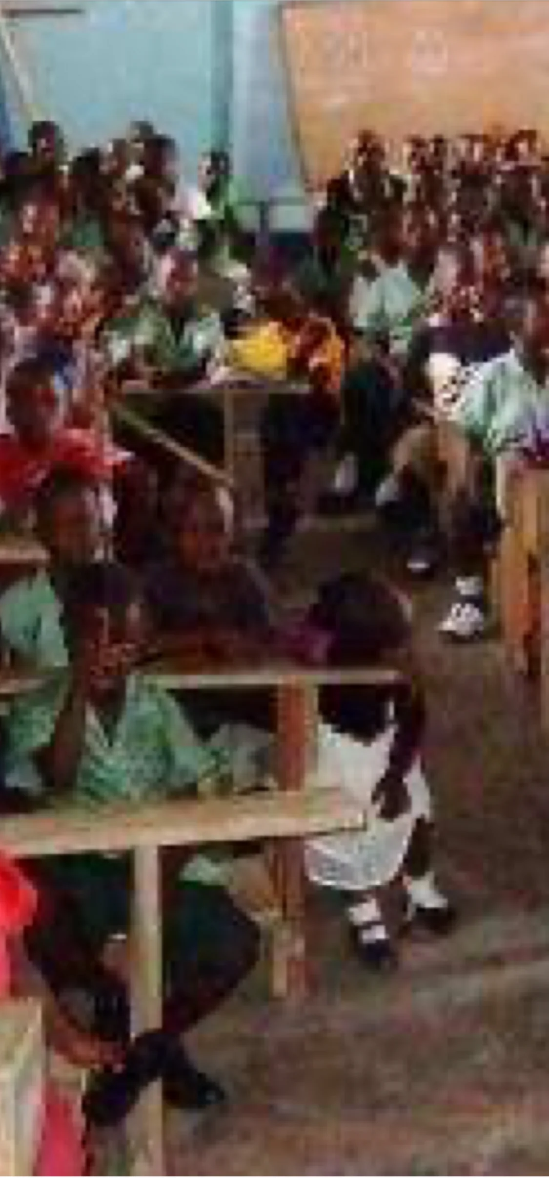Students seated at desks in a busy classroom.